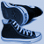 Two side-by-side pixelated images: a dark blue high-top sneaker with white laces and stripes on a light blue background, and a circular Converse logo with a star and text on a black background.