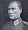 Black-and-white portrait of a person in military uniform with white collar insignia, next to blue text reading "Atam izindeyiz" on white background.