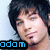 A pixelated image of a person with dark hair and light skin, featuring blue text reading 'adam' at the bottom left.