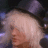 Pixelated close-up of a person with light-colored hair and closed eyes, set against dark background elements.