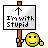 A 48x48 pixel animated contact sheet showing two frames: a sign held by a yellow smiley face and green text reading "Original Icons .com" on dark green background.