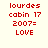 Red pixelated text on a light background reads 'lourdes cabin 17 2007= LOVE' in three , with a gray rectangle partially visible on the right edge