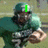 A football player in a green uniform holding a ball, with changing text overlays