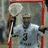 Pixelated image of a lacrosse goalie in white uniform holding a stick, with blue text reading "Lacrosse Goalies" and "Rock So step Out of My Crease!" on black background.