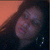 A pixelated image of a person with long dark hair and hoop earrings, alongside pink text on black background reading "PuLI TcH TrlGgEr Now Str8 IN Teh heart".
