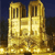 Pixelated golden structure with two towers and central archway against dark blue background, rendered in low-resolution style.