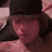 A pixelated image of a person with long dark hair wearing a black cap, showing two states: one without text and another with blue 'Jorge!' text above the head.