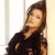 A pixelated image of a person with long brown hair leaning against a light-colored wall, next to green text reading "Original Icons .com" on a dark background.