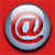 Circular icon with metallic silver gradient center on red background, featuring stylized @ symbol in red and white tones.