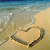 Beach scene with heart drawn in sand, waves lapping at shore; four- shows identical static image across all