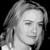 A grayscale pixelated portrait of a person with closed eyes, shoulder-length hair, and a neutral expression against a black background.