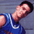 Pixelated static image of a person in blue clothing with visible facial features and partial body, set against a gray background.