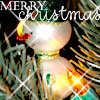 A static Christmas-themed icon featuring a white bauble ornament with green accents, surrounded by pine branches and glowing lights, with 'MERRY Christmas' text overlaid.
