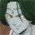 Static pixelated image of a person wearing a light-colored head covering and dark clothing against a dark green background.