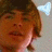 A pixelated close-up of a person with light brown hair and fair skin, showing two side-by-side views where the right view has slightly more visible facial features.