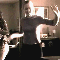 A 4-frame contact sheet of a person dancing in a dimly lit room with visible motion blur and light reflections on their clothing.
