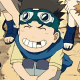 Animated cartoon character with goggles, blue scarf, and yellow shirt grinning widely in a pixelated style.