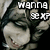 Pixelated image of a character with dark hair and a light-colored top, overlaid with white blocky text reading "WANNA" and "BE MY".