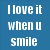 Blue background with white pixelated text reading "I love it when u smile" on left and "Cuz... it makes me" on right.