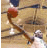 Animated sequence showing a basketball player in white uniform dribbling and shooting on wooden court with red ball.