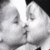 Two faces in close proximity with a blurred background, rendered in grayscale tones.