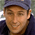 A pixelated close-up of a person wearing a dark blue cap and dark clothing, with a blurred background.