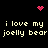 Black background with repeated text and pixelated pink symbols; text reads 'i love my joelly bear' in two with a heart and starburst above and below
