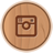 Circular wooden-textured icon with a brown square frame containing a simplified camera symbol in the center.