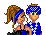 Pixel art buddy icon showing two cartoon characters in a close pose against gray background, one with long brown hair and blue streaks, the other wearing blue checkered headwear and shirt.