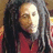 Pixelated static image of a person with long dark hair wearing a red garment against a blurred background.