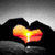 Animated icon shows hands forming a heart shape with a sunset scene inside, text above changes from 'L' to 'LO' to 'LOU' to 'LOVE' across frames.