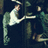 Pixelated image of a person in white clothing reaching toward another figure, with red text reading "I'd Give Up For Ever To Touch You" on black background.
