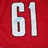 Red jersey with white number 61, hockey goal net, and green text 'Hockey is Life' on gray background.