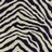 Black and white striped pattern with irregular, flowing lines on a pixelated background.