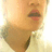 Pixelated close-up of a person's face showing mouth and chin with light skin tone, wearing a brown garment with dark trim against a light background.