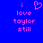 Blue background with pink pixelated text reading "i love taylor still" and a heart symbol replacing the 'o' in 'love'.