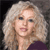 Static 50x50 pixel icon of a person with light-colored curly hair and dark clothing against a dark background, rendered in low-resolution pixel art style.