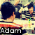 A pixelated image of two people in a striped-shirt setting with text labels and a red symbol, showing animation changes across frames.
