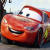 Pixelated static image of a red anthropomorphic race car character with large eyes and a wide smile, rendered in low-resolution style on a light background.