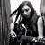 A 50x50 pixel animated buddy icon featuring a grayscale image of a person with long hair on the left and green text reading "Original Icons .com" on a dark green background on the right, displayed as a contact sheet with two frames.