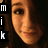 Pixelated close-up of a person's face with warm brown tones, partially obscured by a black vertical bar containing white text characters.