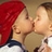 Pixelated static image of two people kissing with one person wearing a red head covering and the other in light-colored clothing against a neutral background.