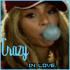 A person with long blonde hair and a red cap blows a light blue bubblegum bubble, with text reading 'Crazy IN LOVE...' below.