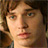 Static 48x48 pixel icon showing a close-up of a person's face with brown hair and green eyes, rendered in low-resolution pixel art style.