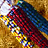 Pixelated static image of abstract colorful shapes on a brown background with no visible text or distinct subjects.