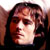 Static pixelated image of a person's face with dark hair and light skin tones, rendered in low resolution with visible dithering and color blending.