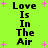 Bright green background with pink starbursts and repeated black text 'Love Is In The Air' in pixelated font.