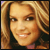 Pixelated close-up of a smiling person with light brown hair and warm skin tones in a static 50x50 icon format.
