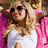 A pixelated image of a person with long blonde hair wearing sunglasses and a pink jacket over a white top, with pink text reading "I need... FABULOUS" on a white background.