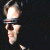 Pixelated image of a person with dark hair and sunglasses on the left, next to green text reading "Original Icons .com" on a solid background.